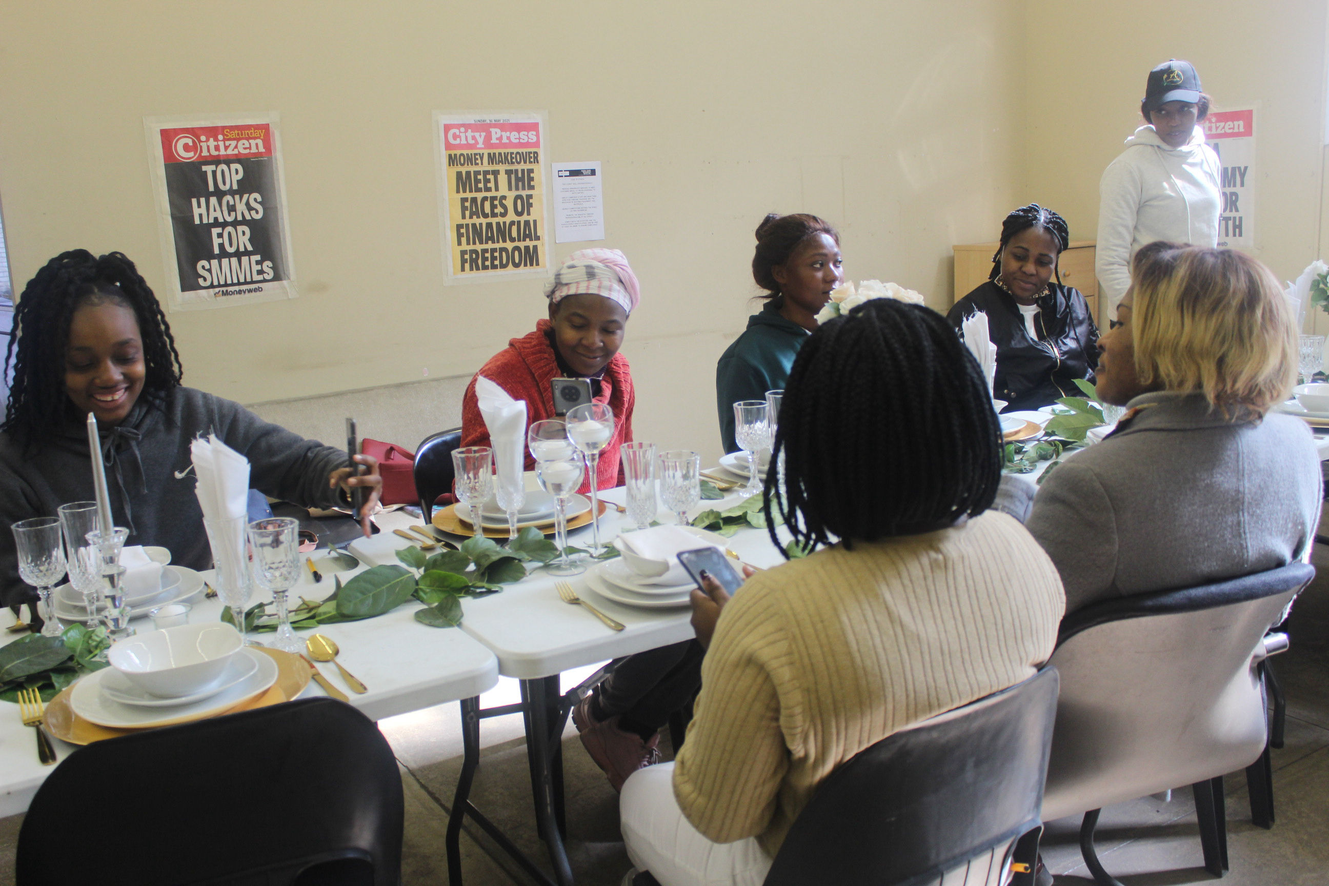 The Outreach Foundation décor students sitting at the table that they worked on
